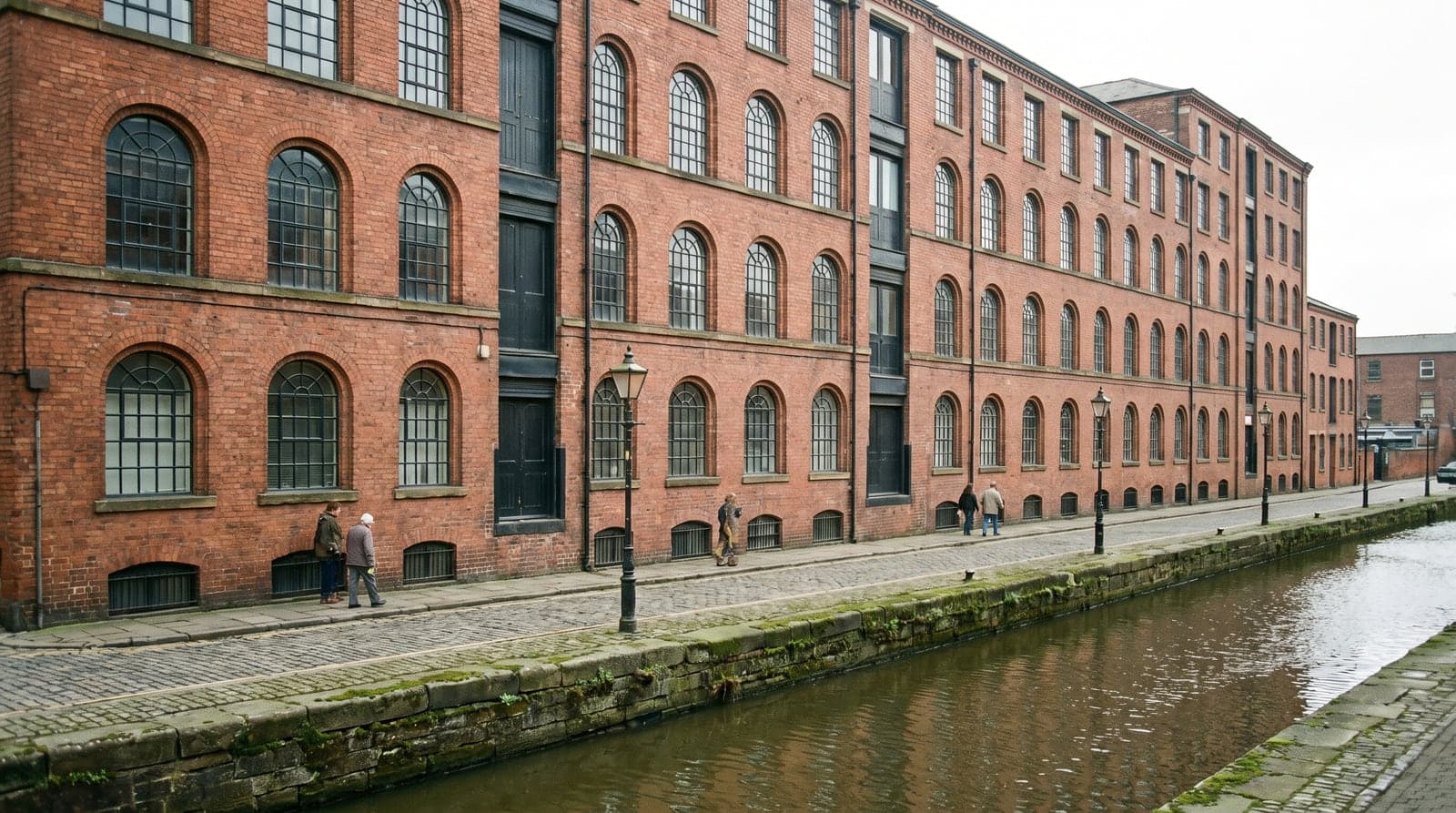 A converted red-brick Victorian mill of the kind found across Ancoats, Manchester