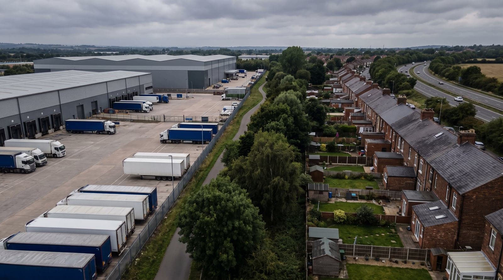 A distribution park and its lorry yard backing directly onto residential gardens