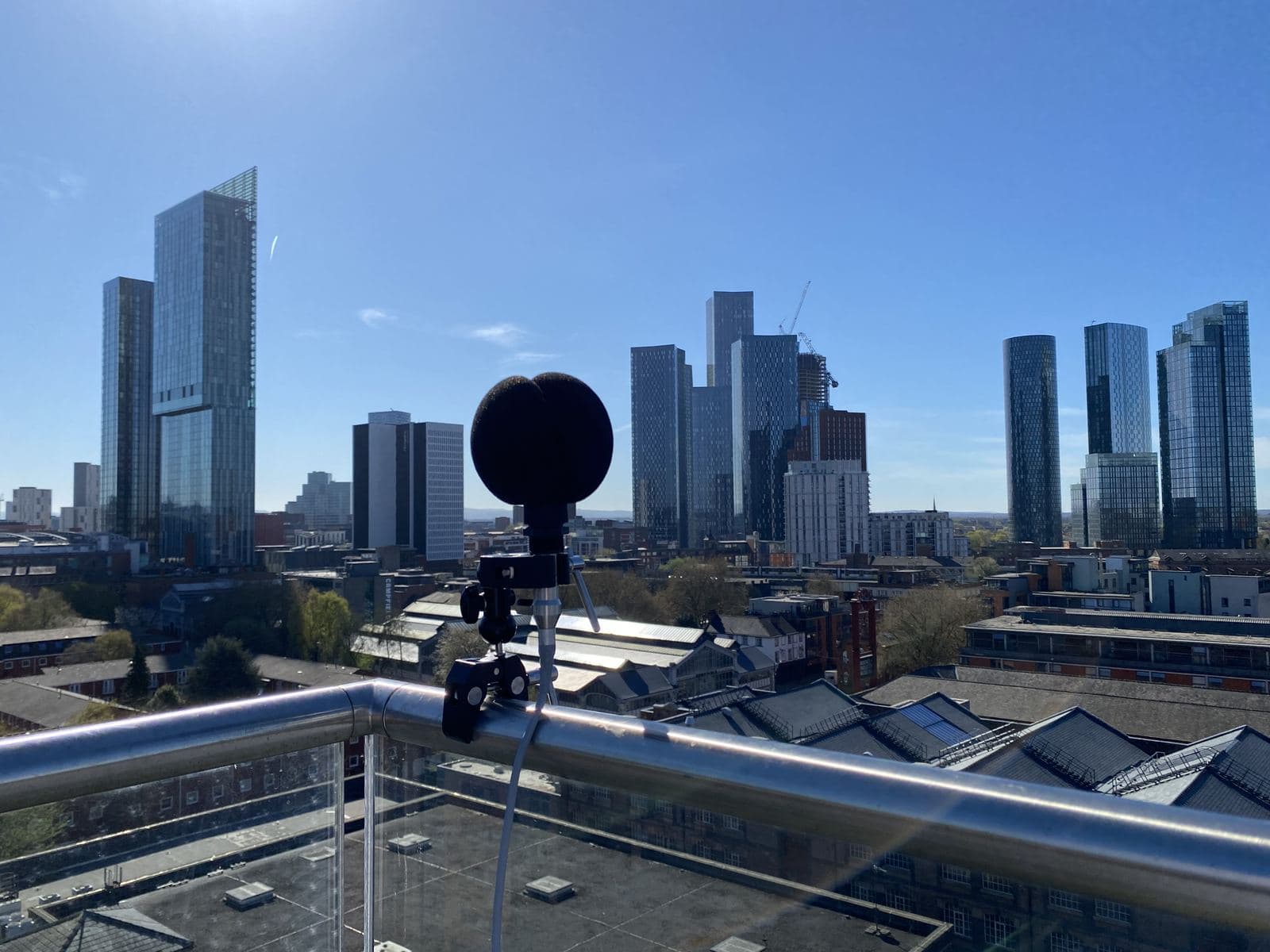 Unattended noise monitoring equipment installed on a city-centre rooftop